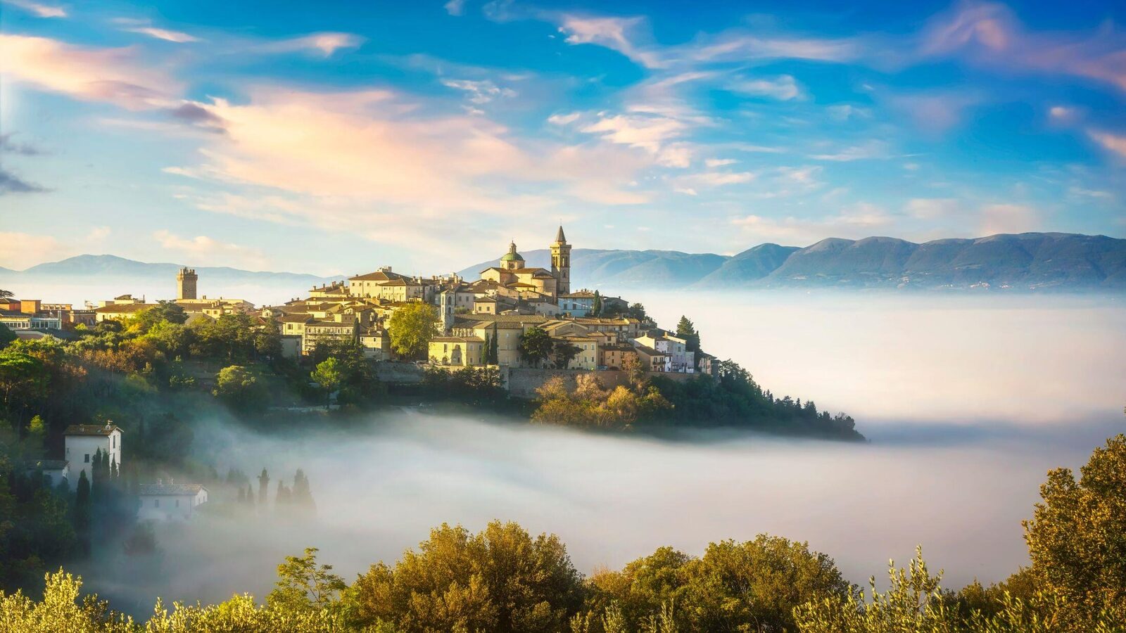 Umbrian hill town in morning mist — where the Lagotto Romagnolo was saved from extinction